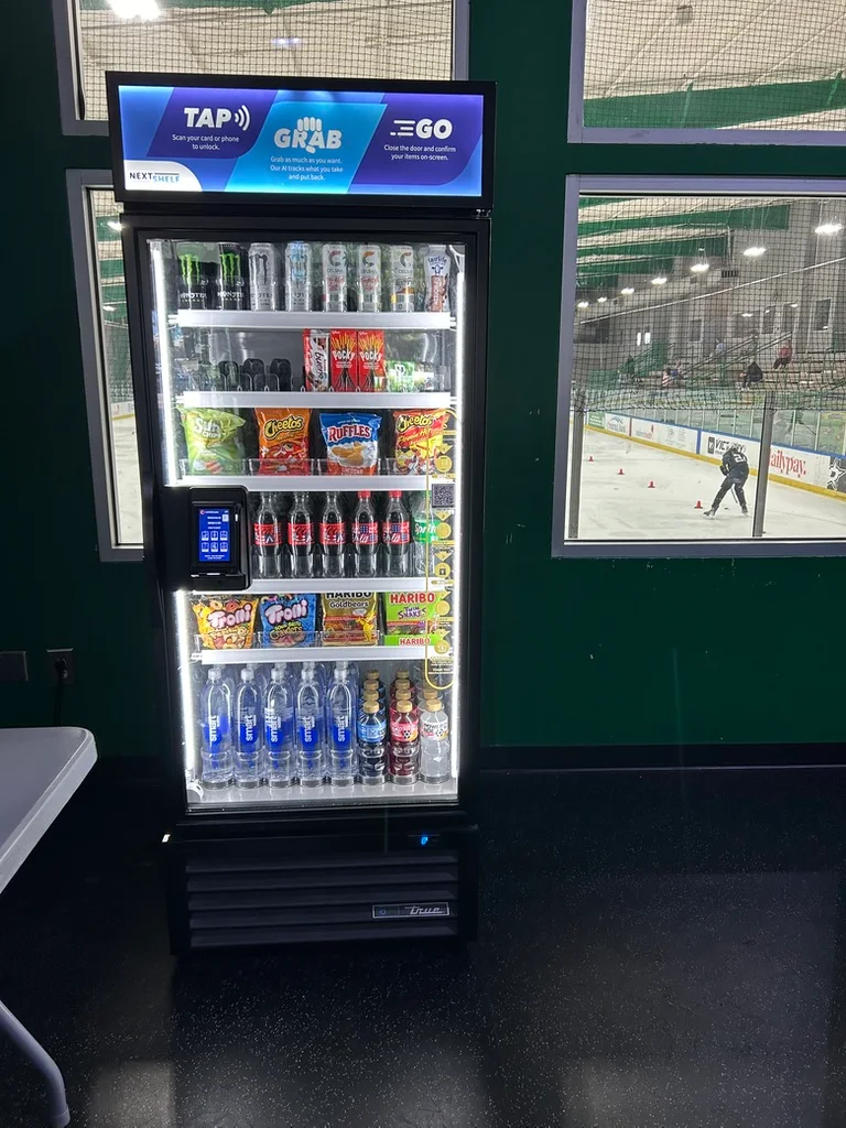 NextShelf managed smart cooler beside an ice rink